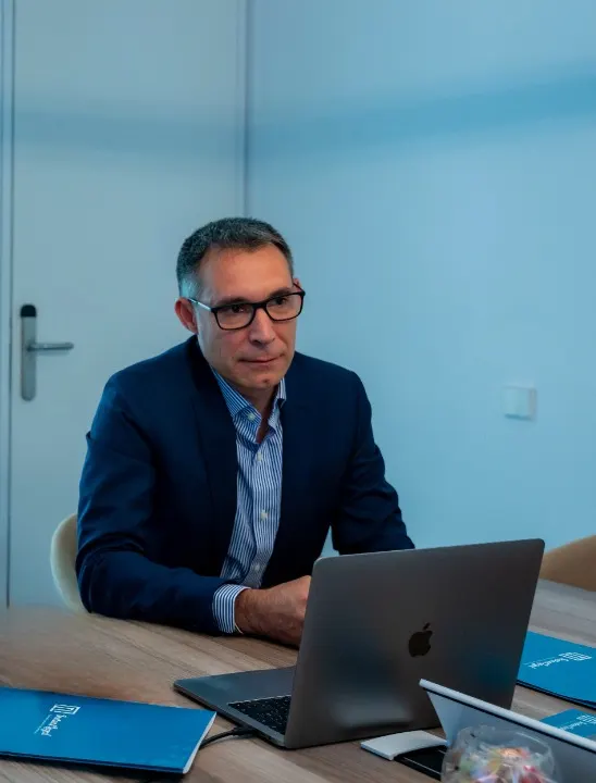José Manuel Pérez working on a laptop at the Instant Legal office